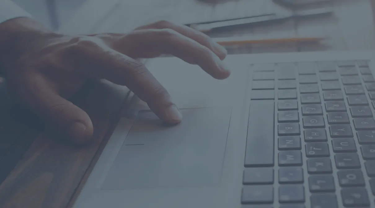 hand using a trackpad on a laptop